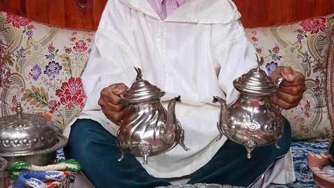 Traditional and ritual preparation of mint tea in Morocco by an old berber - 2 Stock Footage 80359149