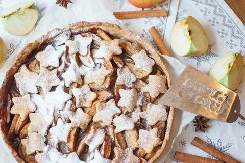 Traditional apple pie on the table with decorations. Stock Photos