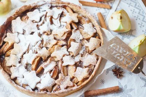 Traditional apple pie on the table with decorations. Stock Photos