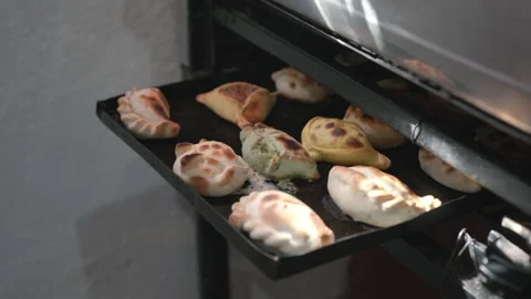 Traditional Argentine empanadas baking inside rustic kitchen oven Stock Footage 336669234