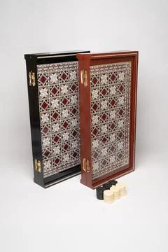 Traditional backgammon board and checkers on display Stock Photos