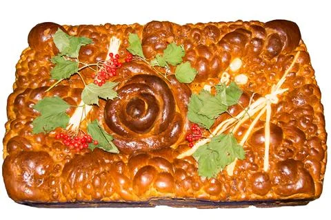 Traditional baked bread with decorative elements displayed on a white background Stockfoto's