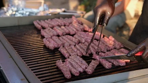 Traditional Balkan cevapi made from minced meat being grilled on a hot barbecue Stock Footage 346692775
