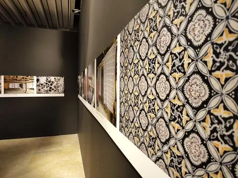 Traditional batik pattern display panel inside a modern art gallery. Stock Photos