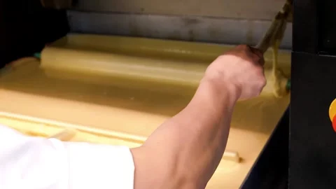 Traditional Baumkuchen Cake Baking Process on Rotating Spit Stock Footage 331774879