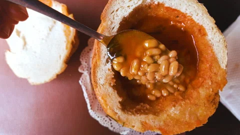 Traditional bean soup served in bread Stock Footage 319848823
