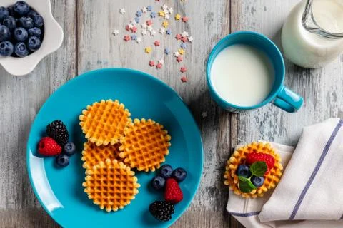 Traditional Belgian waffles with fresh fruit and milk. Flat lay, top view Stock Photos
