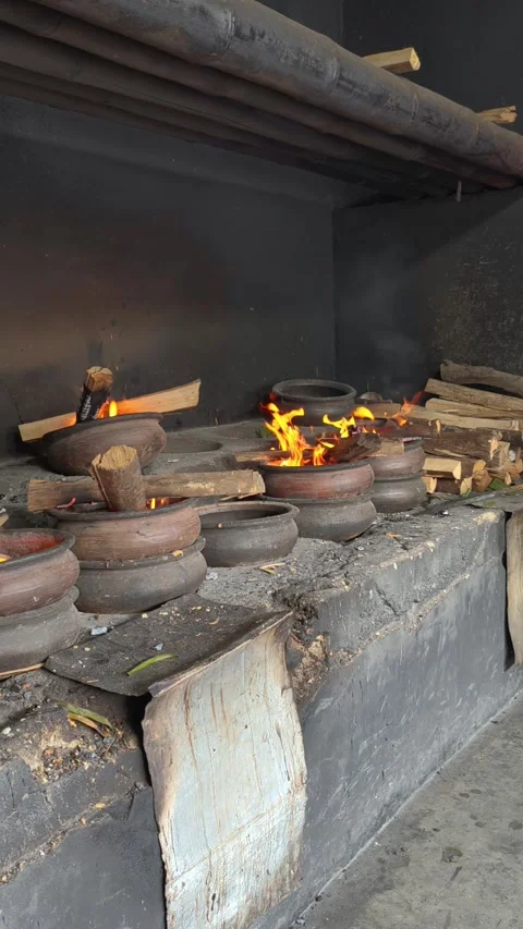Traditional Bika Baking Process with Earthenware Molds and Wood-Fired Heating Stock Footage 339794465