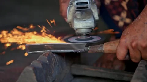 Traditional Blacksmith Polishing Blade in Workshop Close Up 動画素材 346285232