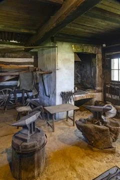 Traditional blacksmith workshop interior showing anvils, tools, and forge i.. Foto stock
