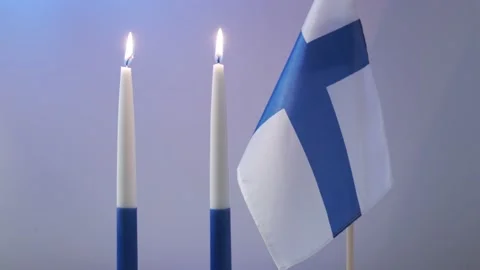 The traditional blue and white candles and flag of Finland Stock Footage 165817543
