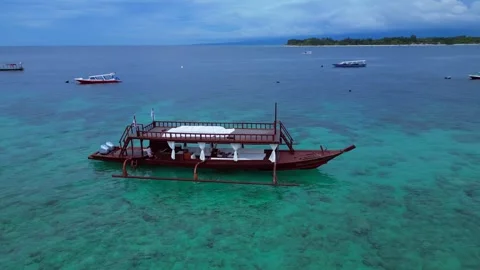 Traditional boat floating on clear turquoise ocean. Nice aerial view drone Stock Footage 345338519