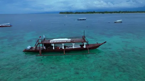 Traditional boat floating on clear turquoise ocean. Magic aerial view drone Stock Footage 345338545