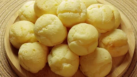 Traditional Brazilian Cheese Bread Stack Rotating In Rustic Wooden Bowl Stock-Footage 337273307
