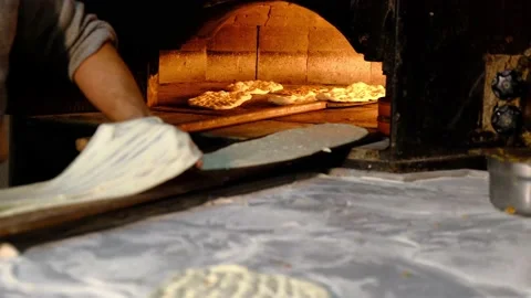 Traditional bread making in stone oven Stock Footage 228069178