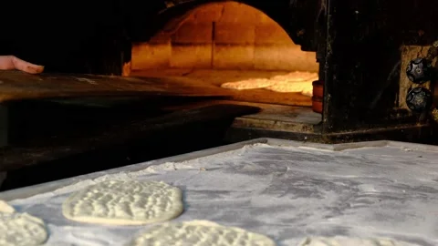Traditional bread making in stone oven Stock Footage 228069805