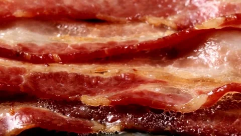 Traditional breakfast featuring fried bacon slices, comforting morning rituals. 스톡 동영상 334642957