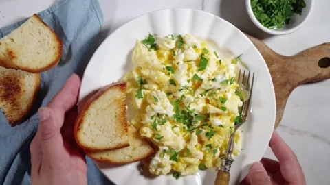Traditional breakfast scrambled eggs with toasted bread Stock Footage 337055300