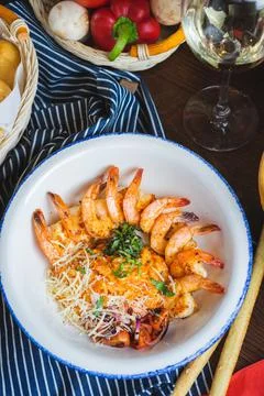 Traditional bright shrimp risotto in a bowl on a table in a restaurant with a Stock Photos