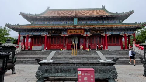 Traditional Buddhist temple hall with incense burner at Tianmen Mountain in Stock Footage 346552355