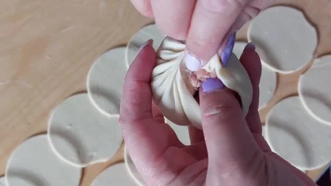 Traditional Buryad Buuz making process. Steamed dumpling filled with meat Stock Footage 292729766