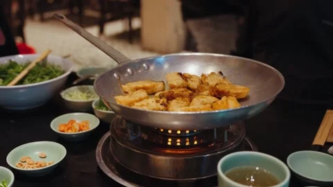 Traditional cha ca fish dish prepared at Cha Ca Thang Long, Hanoi Stock Footage 330049708