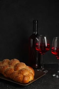Traditional challah bread with wine on dark table. Shabbat Shalom Stock Photos