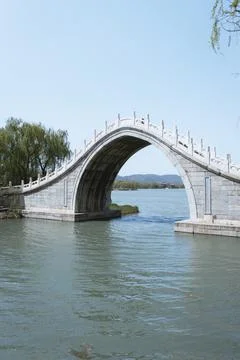 Traditional chinese bridge with a large arch on a calm river Stock Photos