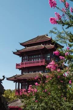 Traditional Chinese temple surrounded by flowers Stock Photos