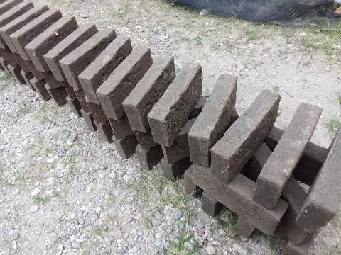 Traditional Clay Bricks Drying Outdoors at Small Scale Brick Production Site Stock Photos