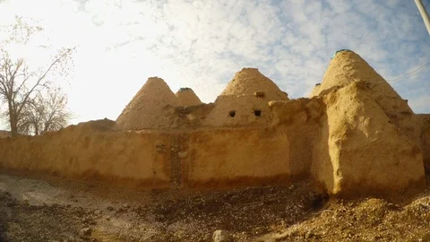 Traditional clay Middle Eastern dwellings in a desert area on the border of Stock Footage 81909193