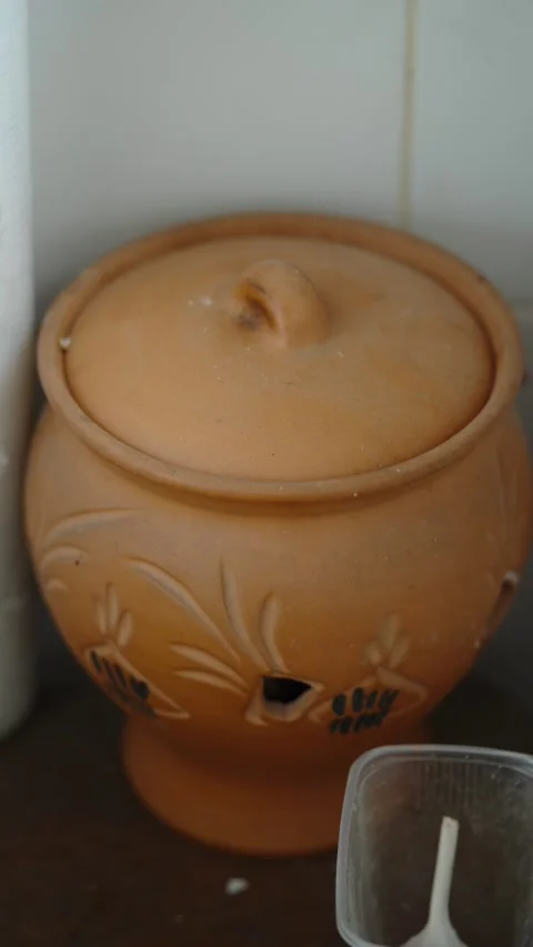 A traditional clay pot with a lid sits on a surface. Stock Footage 339201540