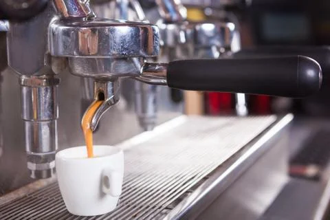 Traditional Coffee maker preparing a cup of espresso coffee. Stock Photos