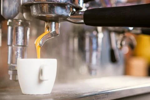 Traditional Coffee maker preparing a cup of espresso coffee. Stock Photos