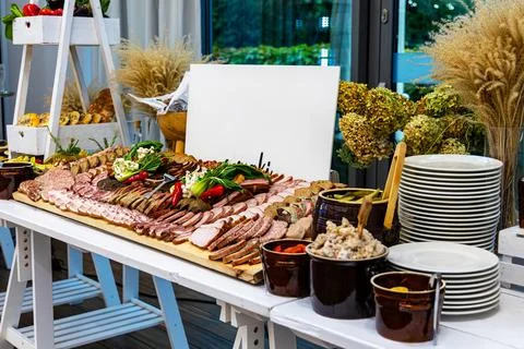 Traditional cold cuts buffet with rustic side dishes. Beautifully arranged Stock Photos