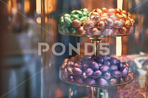 Traditional colorful Easter chocolate eggs in a confectionery storefront in Stock Photos