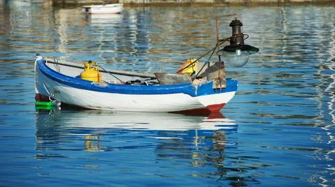 Traditional colourful maltese luzzu fishing boat anchored in harbour, Stock Photos