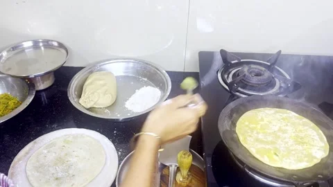 Traditional Cooking of Flatbreads in indian Kitchen Stock Footage 310288981