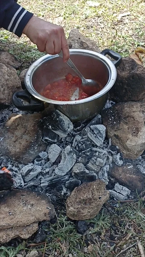 Traditional Cooking on Open Fire in Nature Stock Footage 334580668