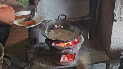 Traditional cooking using a brazier and charcoal Stock Footage 251715678
