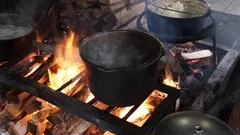 Traditional Cuisine Big Black Pot Cooking Food, Natural Fire With