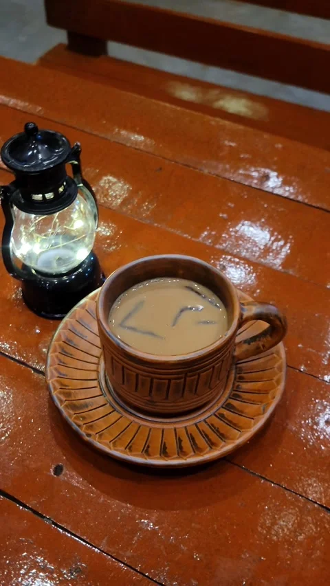 A traditional cup of Masala Tea with a small black lamp Stock Footage 286311275