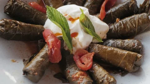 Traditional Dolma Middle Eastern Turkish Dish Meat in Vine Leaves with Yogurt an Stock Footage 220024687