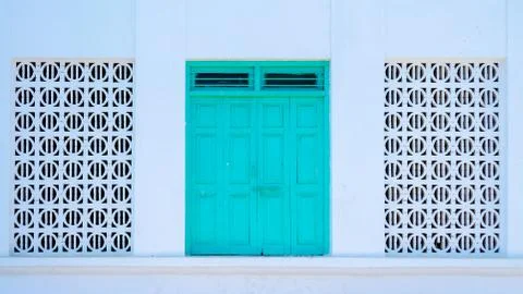 Traditional Door flanked by pattern windows Fotos Stock