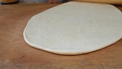 The Traditional Dough Rolling Process utilized in the Culinary Art of baking and Stock Footage 314976202