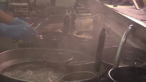 Traditional dumplings boiling during the evening rush Stock Footage 323794325