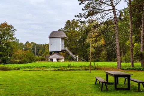 Traditional Dutch primitive windmill without sails on small hill Stock Photos