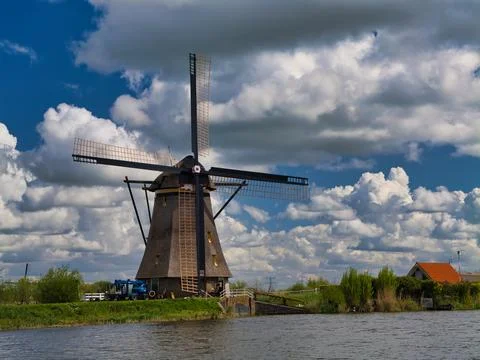 Traditional Dutch Windmill Under Dramatic Clouds Stock Photos