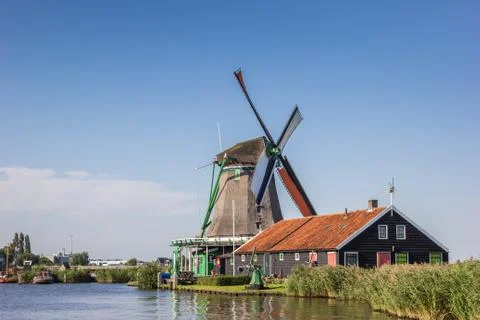 Traditional dutch windmill at the Zaan river Stock Photos