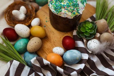 Traditional Easter cake and painted eggs on white background. Stock Photos